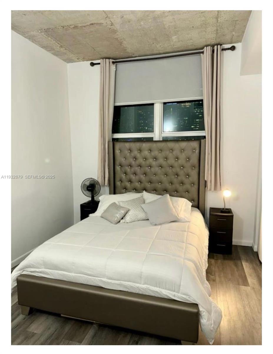 133 Northeast 2nd Avenue, Unit 2108 Miami, FL 33132 - Photo 2 of 5 a bedroom with a bed and a flat screen tv