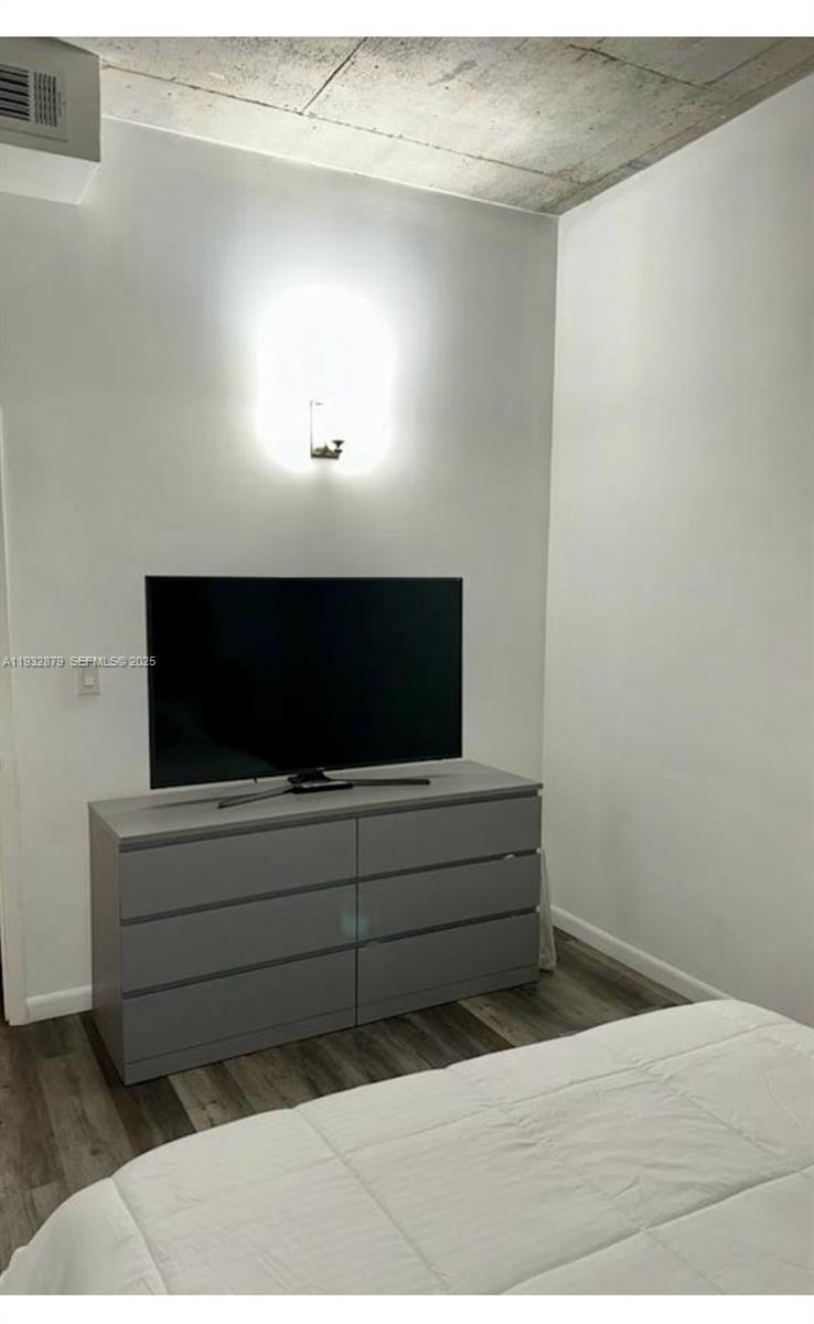 133 Northeast 2nd Avenue, Unit 2108 Miami, FL 33132 - Photo 4 of 5 a living room with a flat screen tv