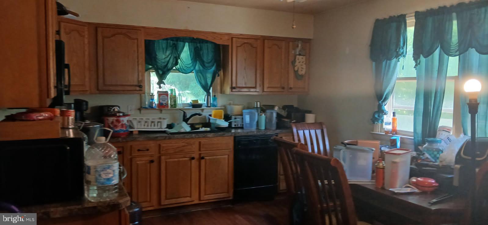 8 Barksdale Court Elkton, MD 21921 - Photo 2 of 3 a kitchen with granite countertop a stove a sink a dining table and chairs