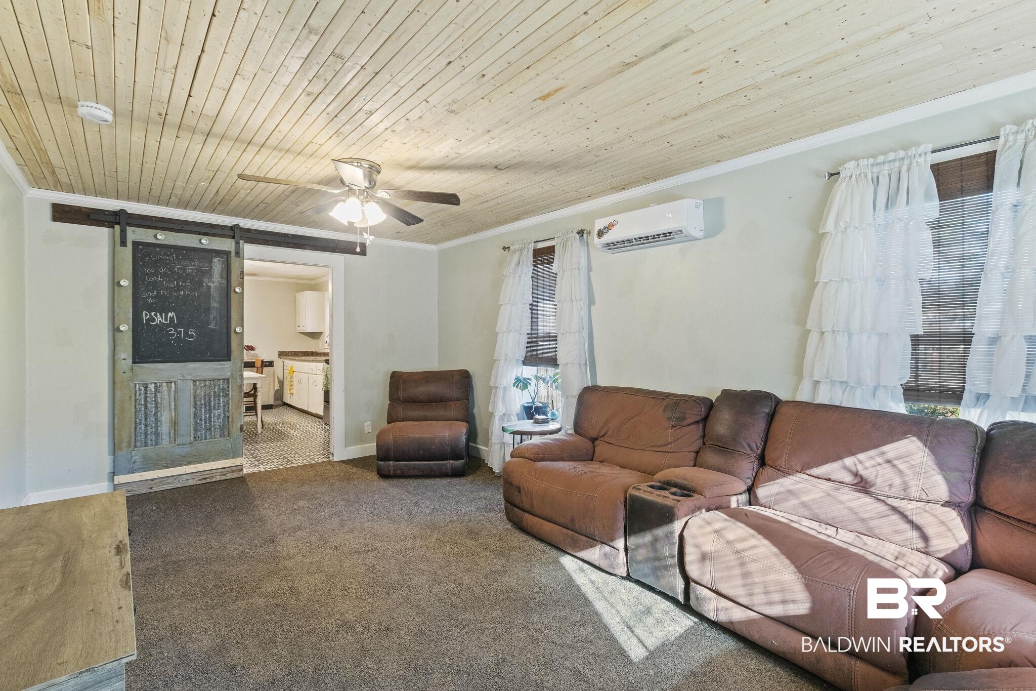 707 North Cedar Street Foley, AL 36535 - Photo 5 of 69 Living room with wood ceiling, a wall unit AC, carpet flooring, a barn door, and crown molding