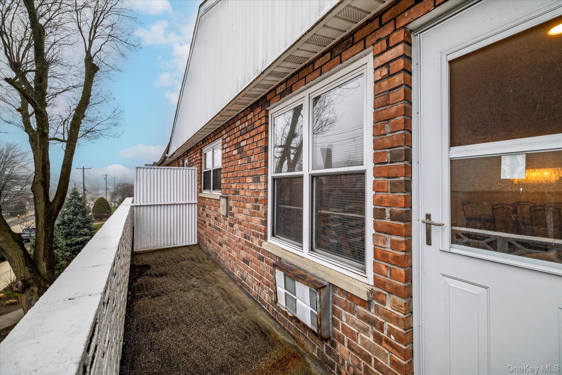 2 Fowler Avenue, Unit 211 Lynbrook, NY 11563 - Photo 16 of 19 a view of a house with a large window