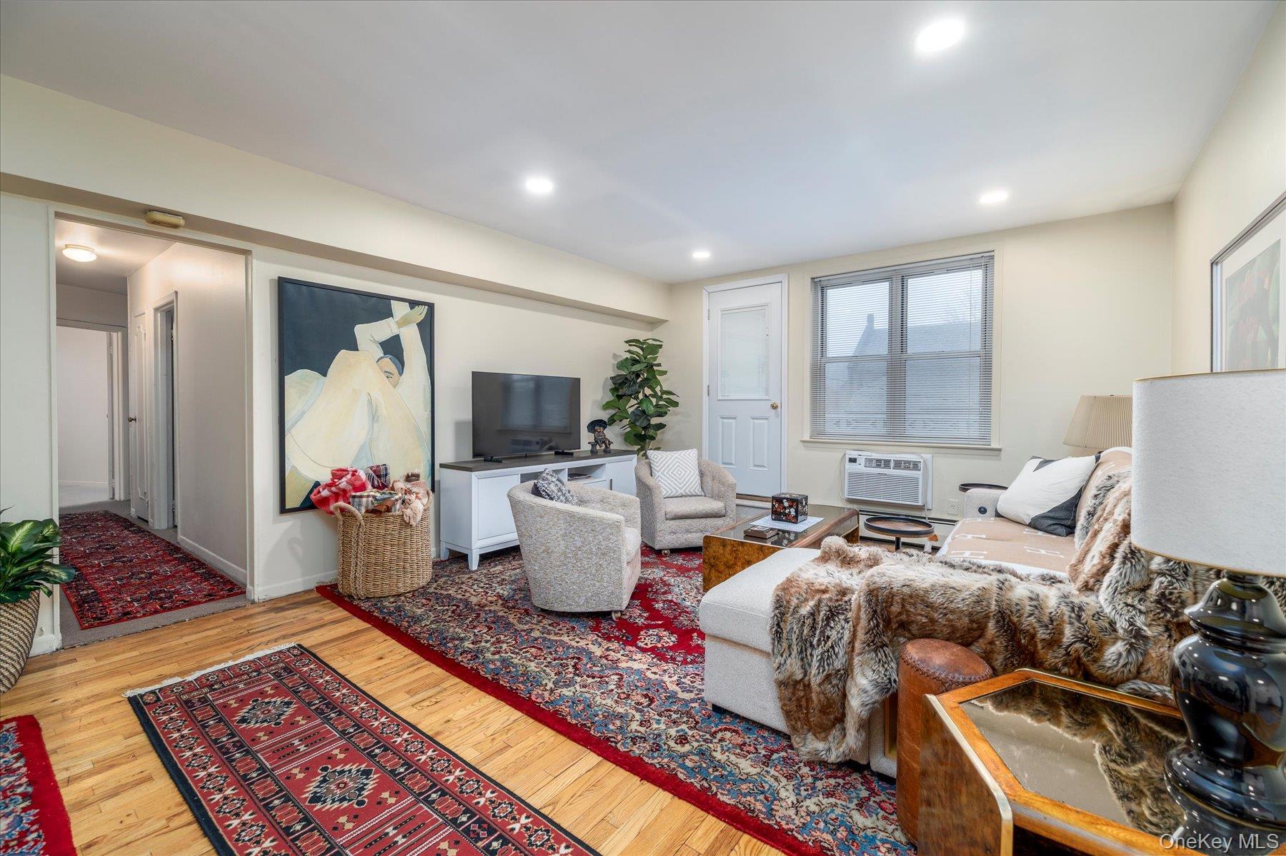 2 Fowler Avenue, Unit 211 Lynbrook, NY 11563 - Photo 6 of 19 a living room with furniture and a rug