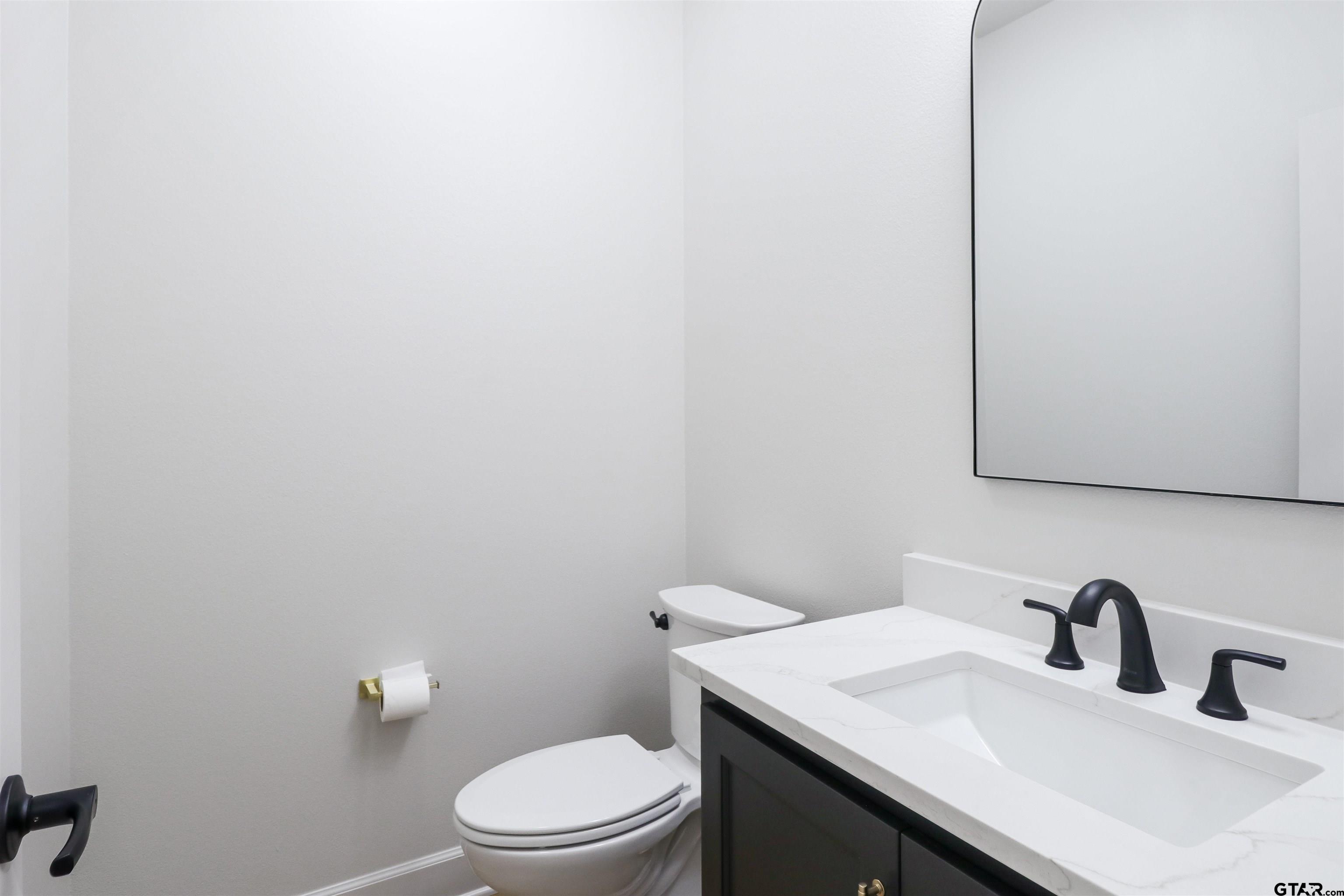 15515 Sugar Ridge Lane Flint, TX 75762 - Photo 17 of 34 a bathroom with a sink and a toilet