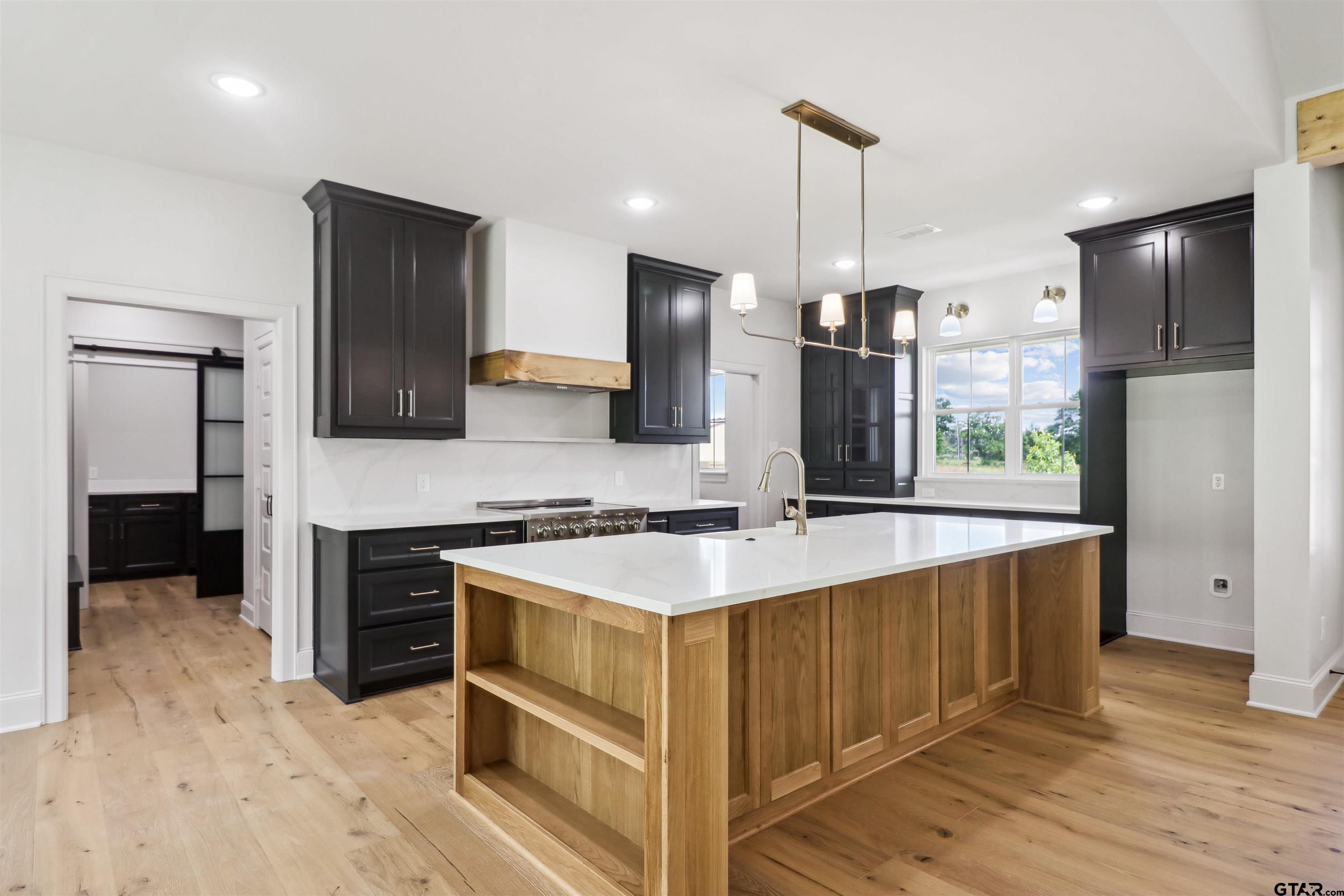 15515 Sugar Ridge Lane Flint, TX 75762 - Photo 8 of 34 a kitchen with stainless steel appliances granite countertop a sink stove and refrigerator