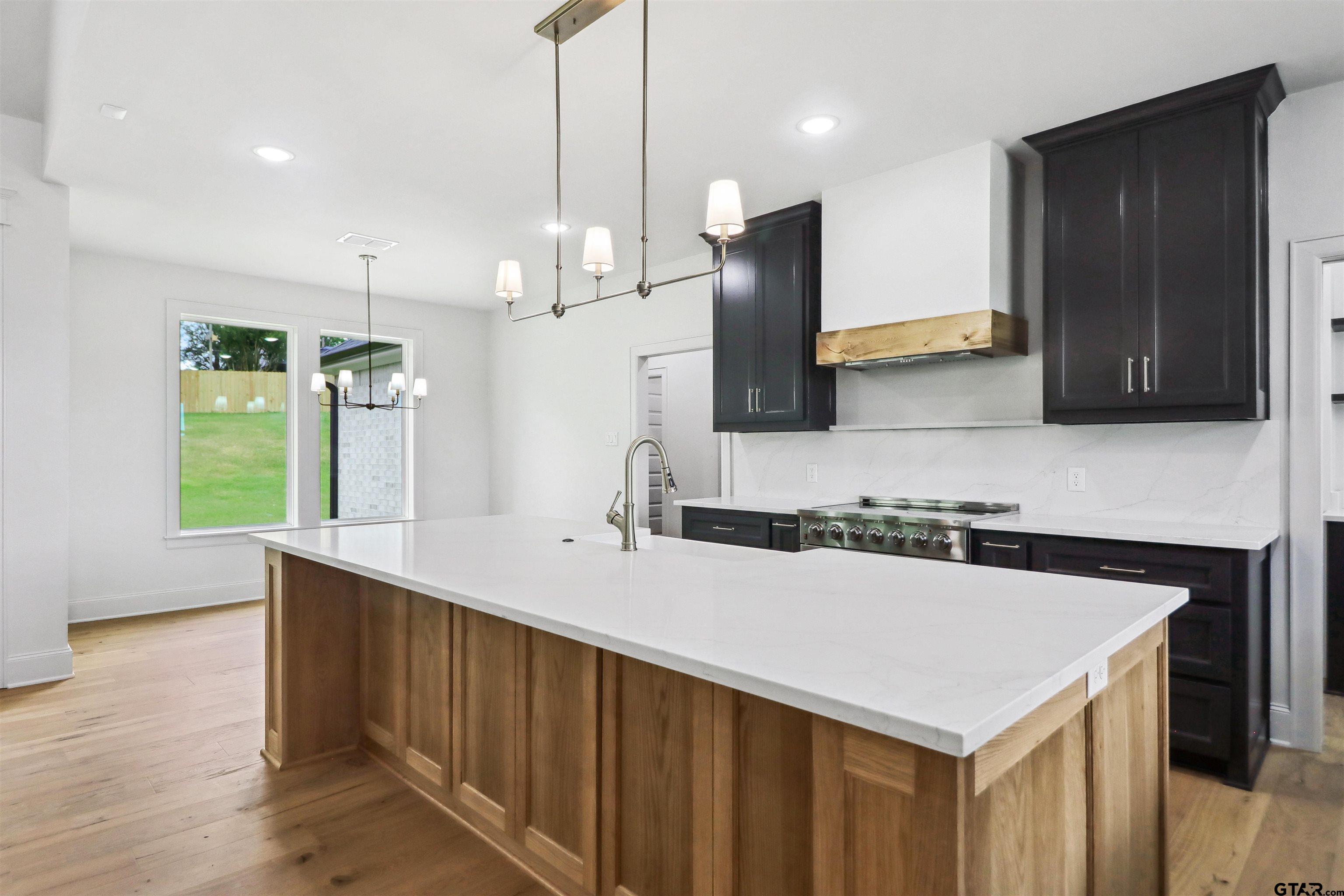 15515 Sugar Ridge Lane Flint, TX 75762 - Photo 9 of 34 a kitchen with a sink a counter space and a refrigerator