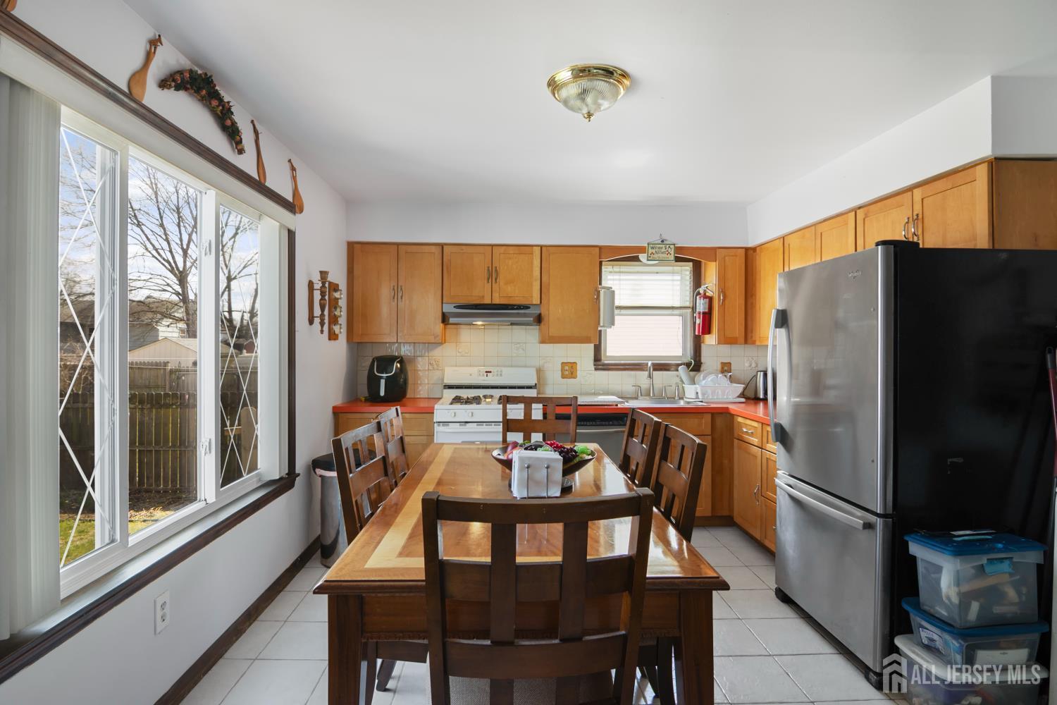 118 Wilton Avenue Middlesex, NJ 08846 - Photo 4 of 24 a kitchen with stainless steel appliances a dining table chairs refrigerator and microwave
