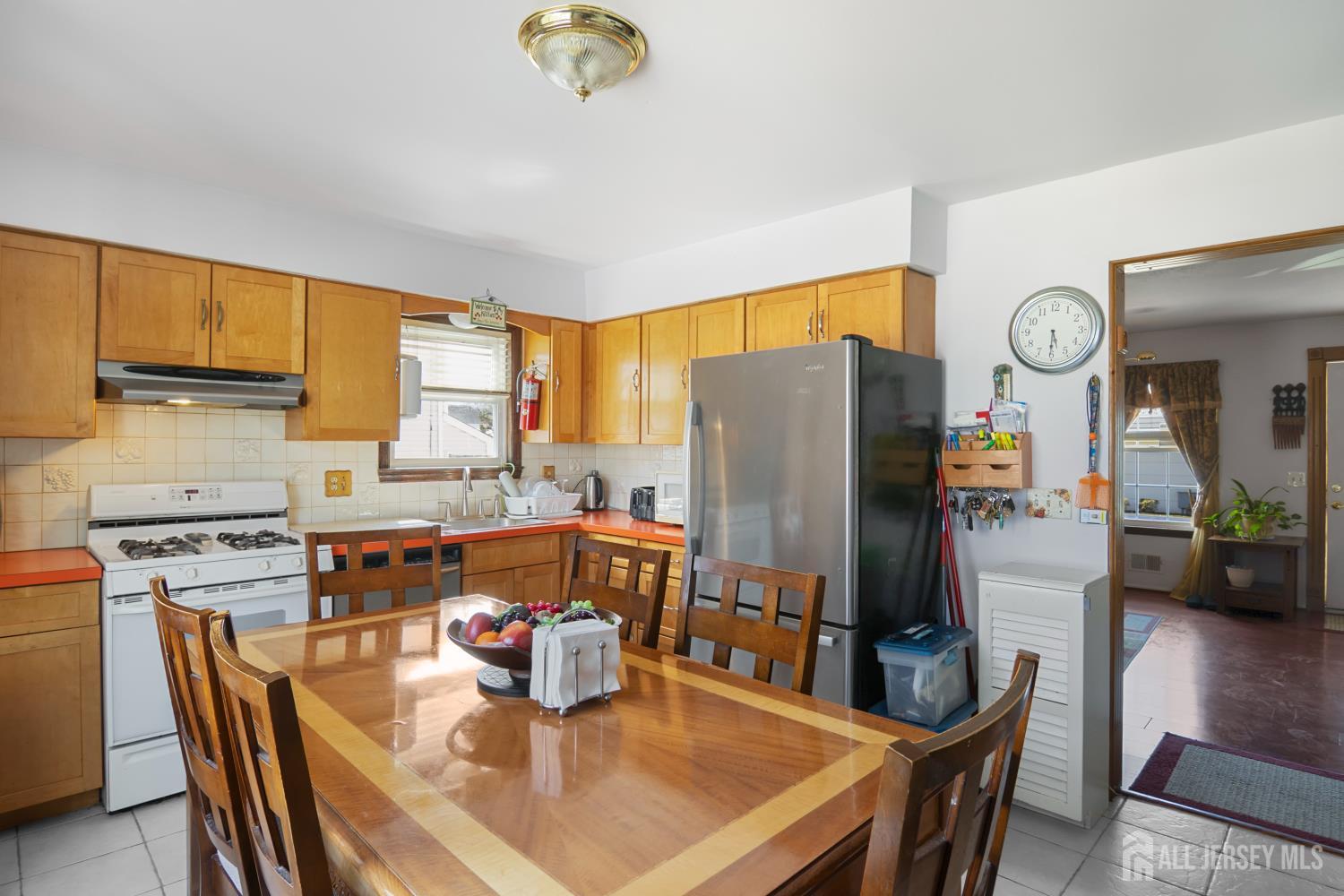 118 Wilton Avenue Middlesex, NJ 08846 - Photo 8 of 24 a kitchen with stainless steel appliances granite countertop a refrigerator a stove a sink a dining table and chairs with wooden floor
