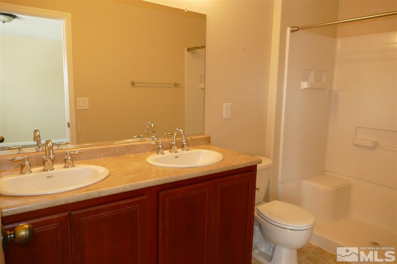 2880 Bryan Street Reno, NV 89503 - Photo 15 of 20 a bathroom with a granite countertop sink toilet and shower