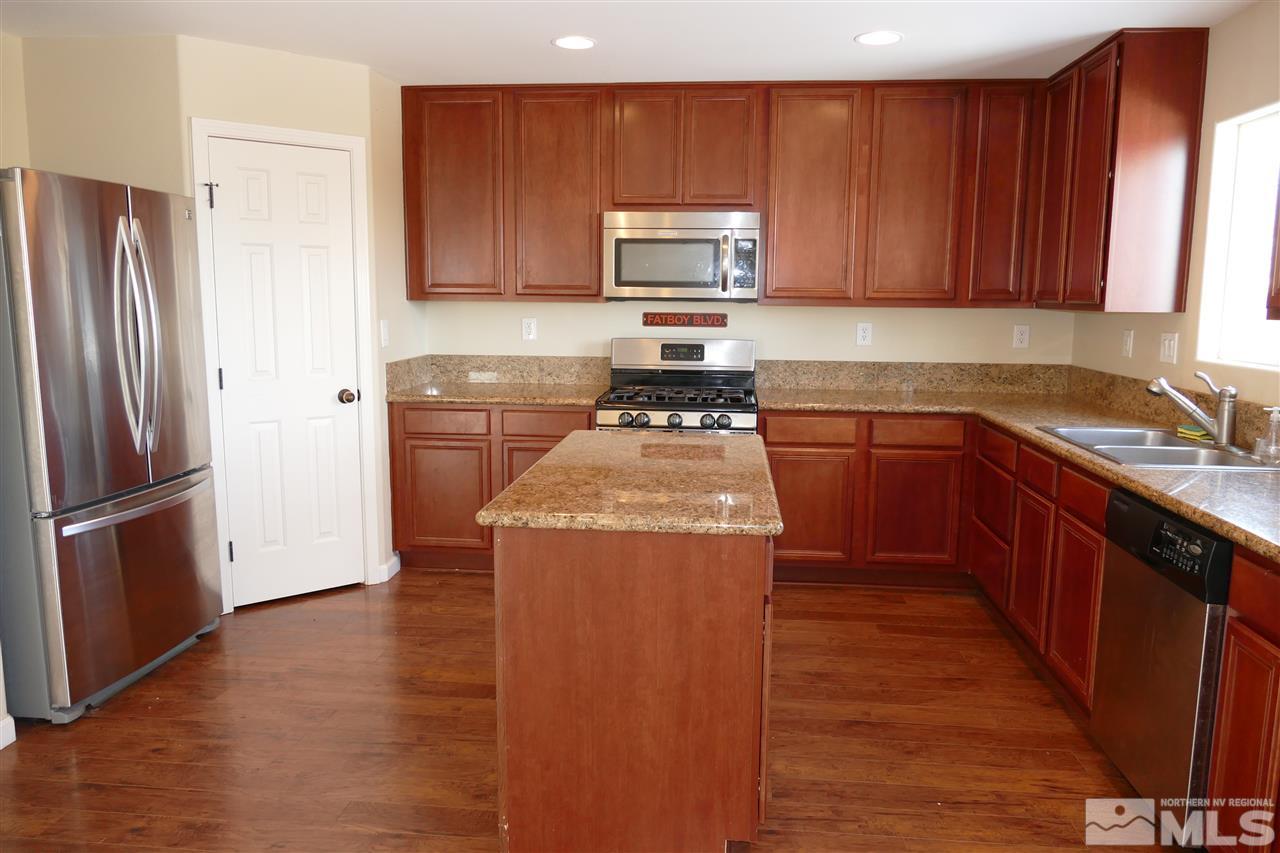 2880 Bryan Street Reno, NV 89503 - Photo 2 of 20 a kitchen with wooden cabinets and stainless steel appliances