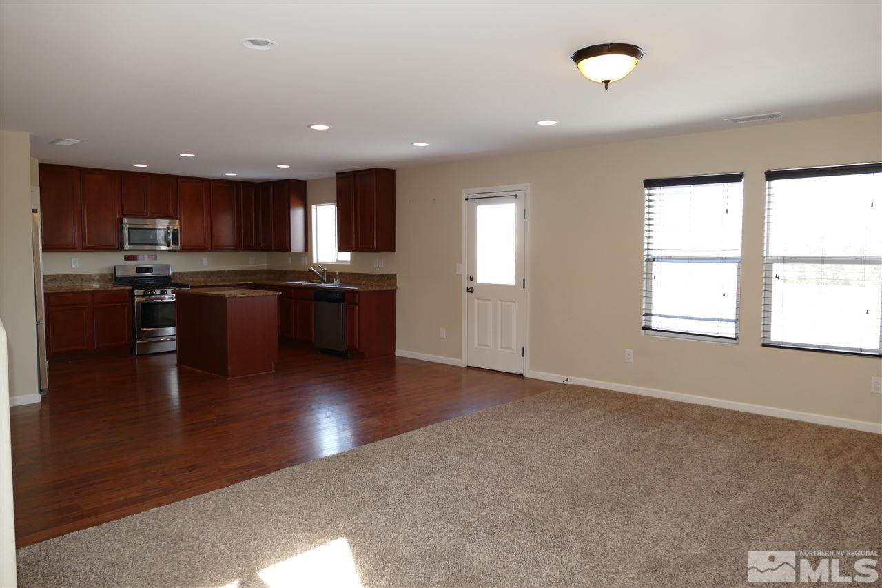 2880 Bryan Street Reno, NV 89503 - Photo 5 of 20 an open kitchen with kitchen island a sink dishwasher a stove and a refrigerator with wooden floor