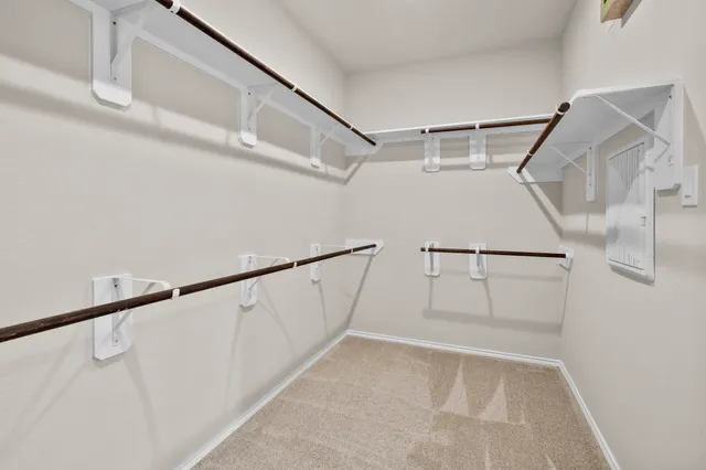 a view of a house with brick walls and a small yard