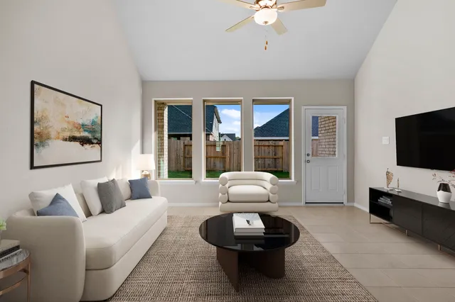 a living room with furniture and a flat screen tv