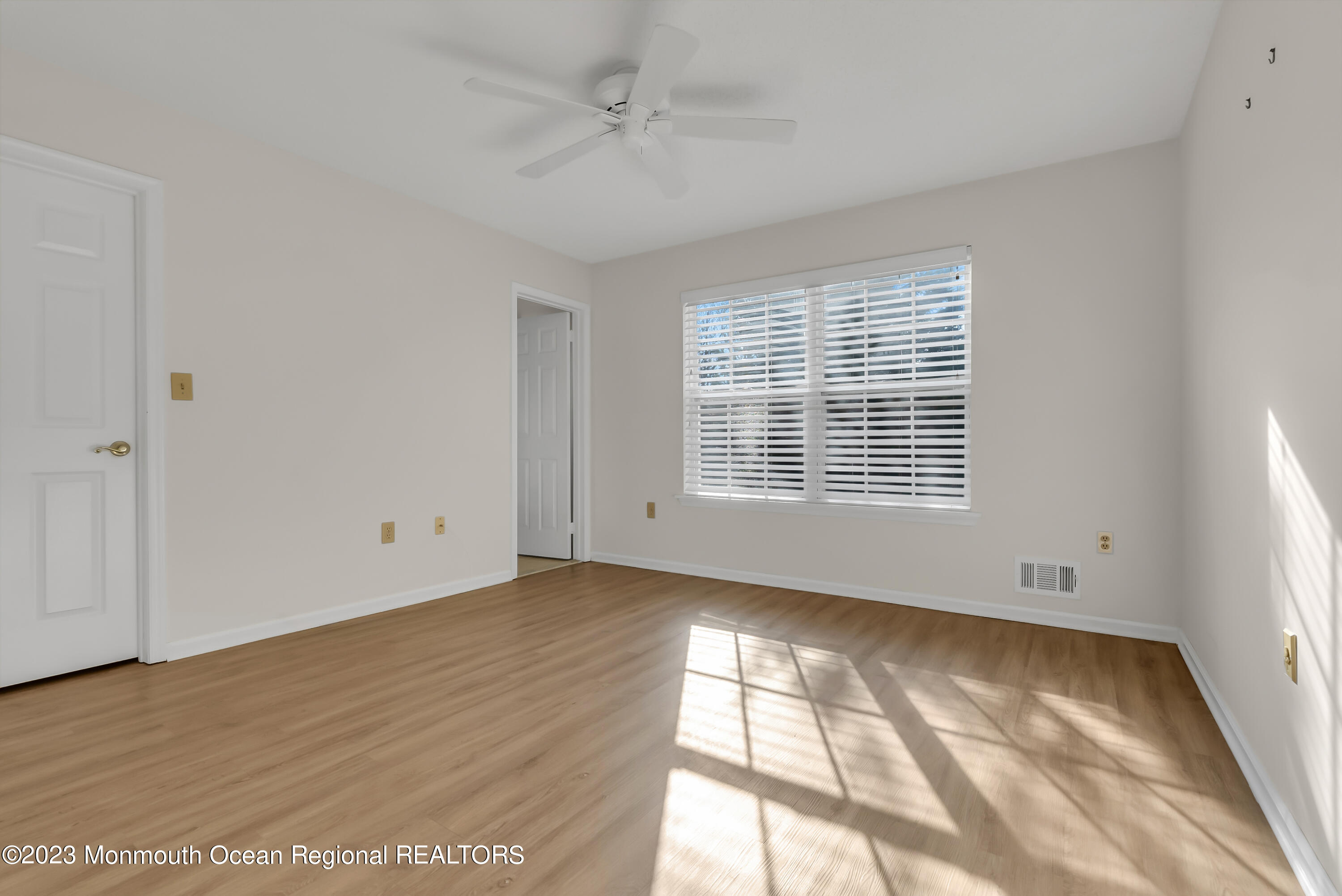 25 Cottontail Drive Brick, NJ 08724 - Photo 17 of 32 a view of an empty room with wooden floor and a window