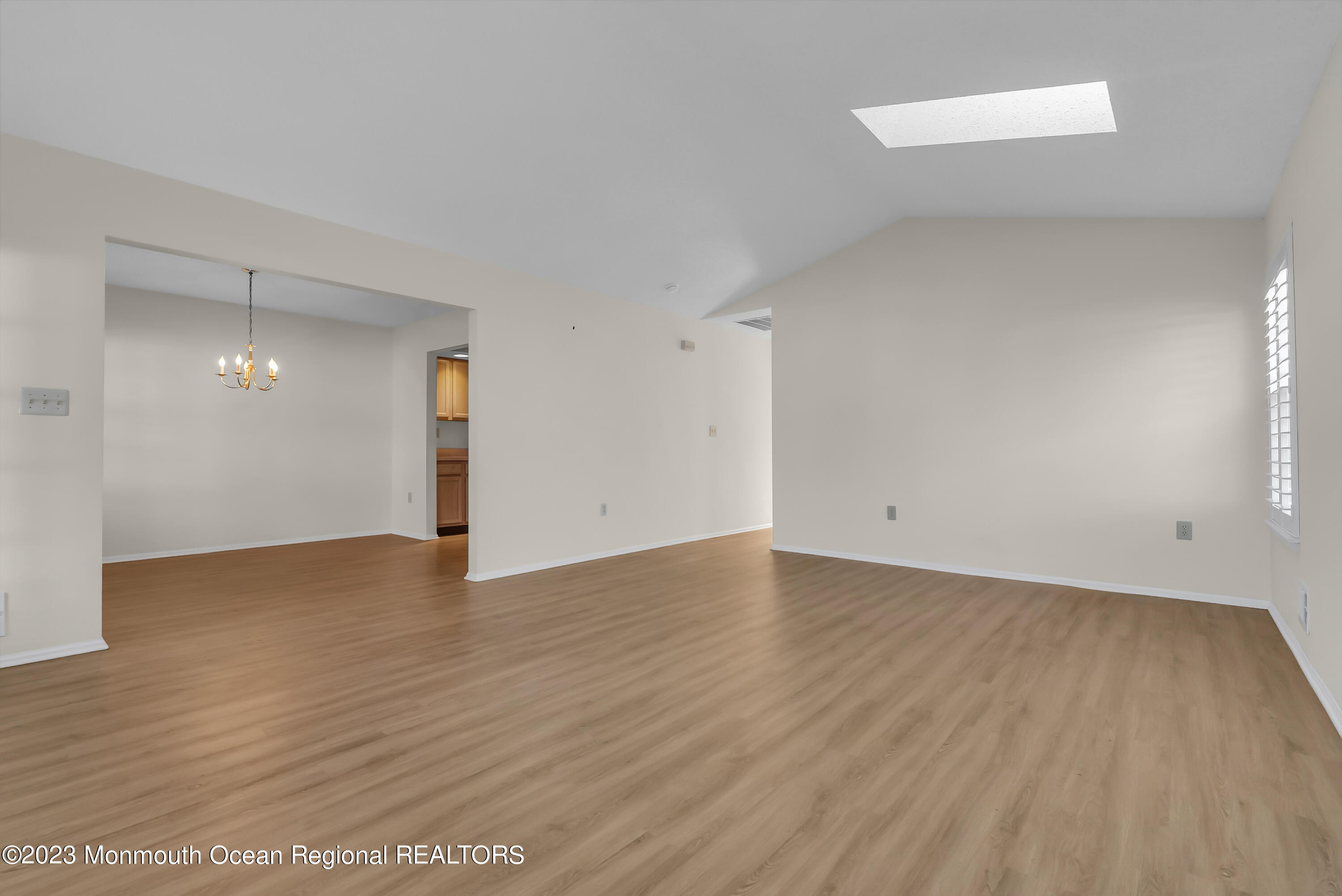 25 Cottontail Drive Brick, NJ 08724 - Photo 8 of 32 an empty room with wooden floor and windows