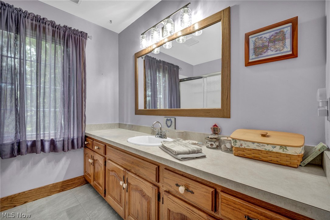 3583 West Bath Road Akron, OH 44333 - Photo 29 of 42 Extended wood-finish vanity with an integrated sink and brushed nickel faucet