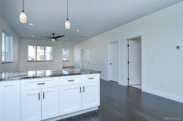 a spacious bathroom with a granite countertop sink and a mirror