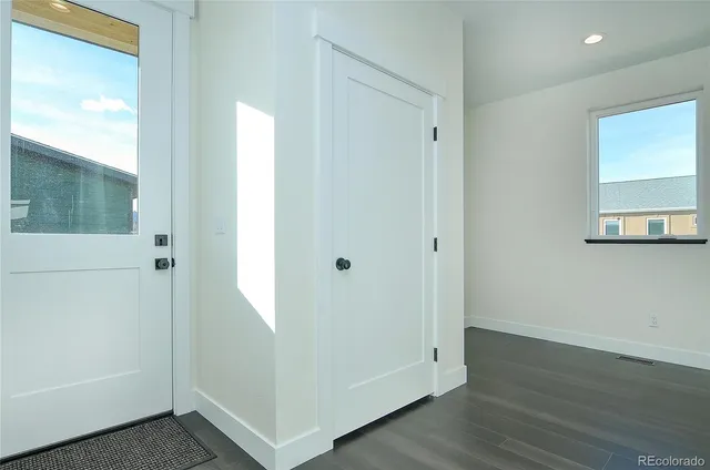 a view of a hallway with wooden floor