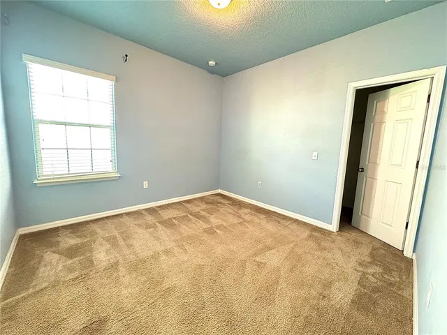 a view of an empty room and a window