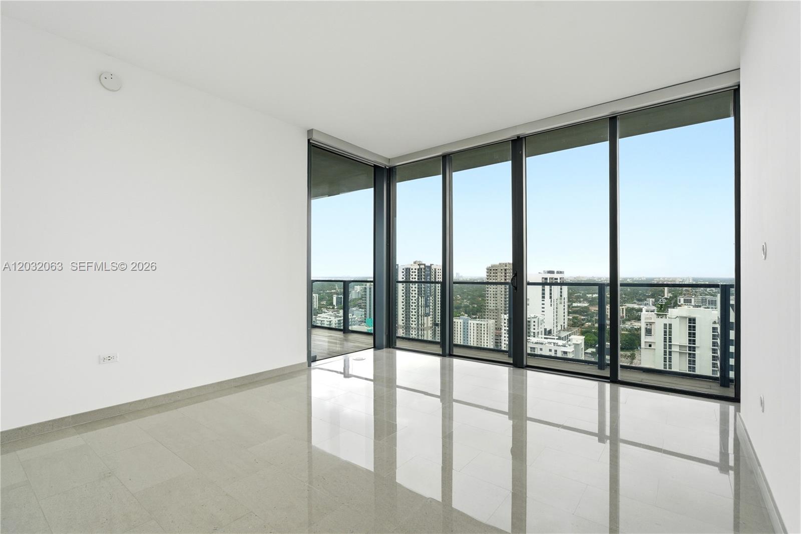 88 Southwest 7th Street, Unit 2302 Miami, FL 33130 - Photo 10 of 26 a view of an empty room with a window