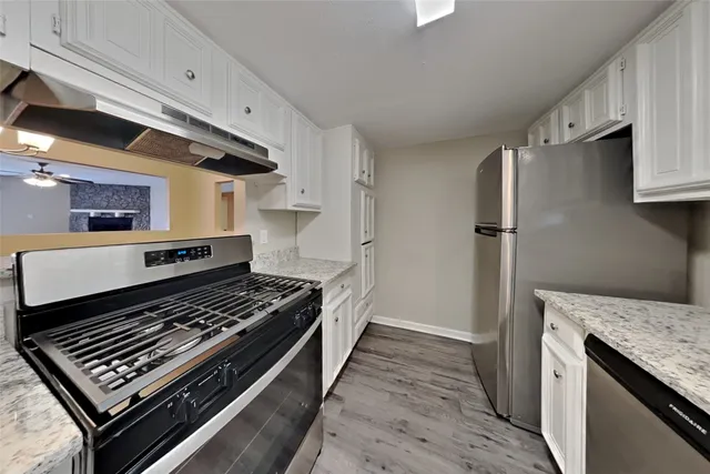 a kitchen with sink stove and refrigerator