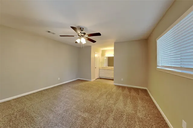 an empty room with a empty space and a ceiling fan