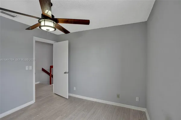 en empty room with window and a fan