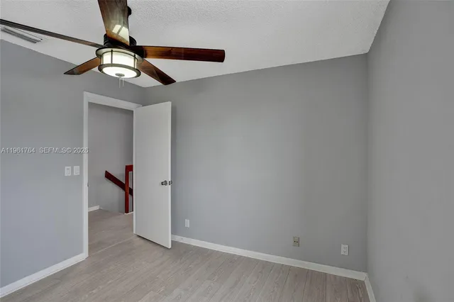 en empty room with window and a fan