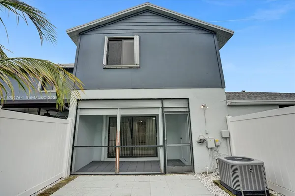 a view of a house with a large window and yard