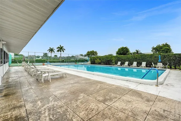 a view of a swimming pool with a yard