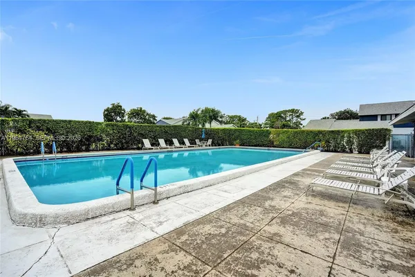 a view of a swimming pool with a lounge chair