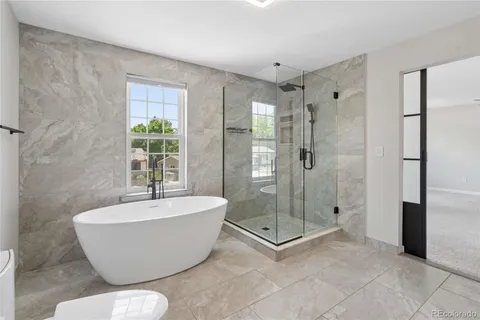 a bathroom with a bathtub and shower