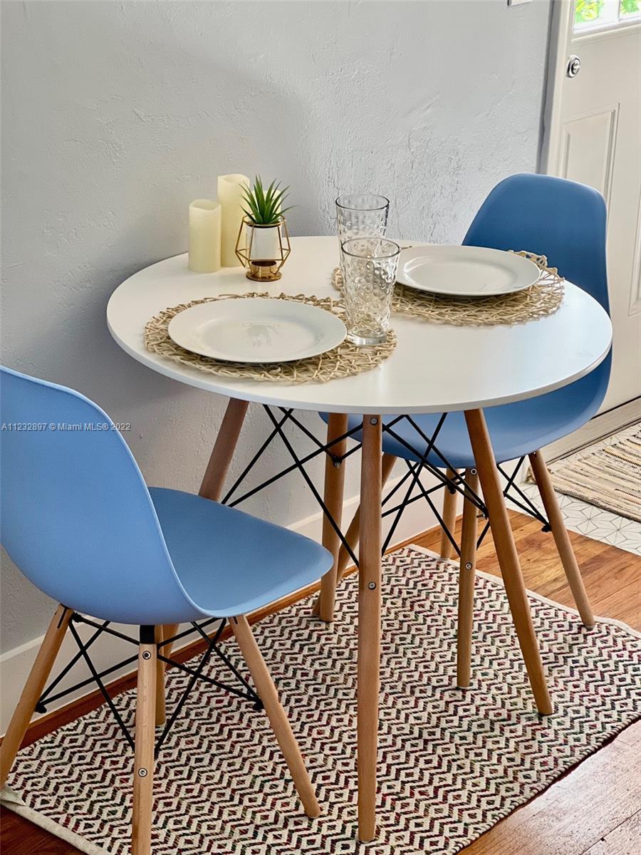 3095 Southwest 21st Street, Unit 1 Miami, FL 33145 - Photo 11 of 15 a view of a dining room with furniture and wooden floor