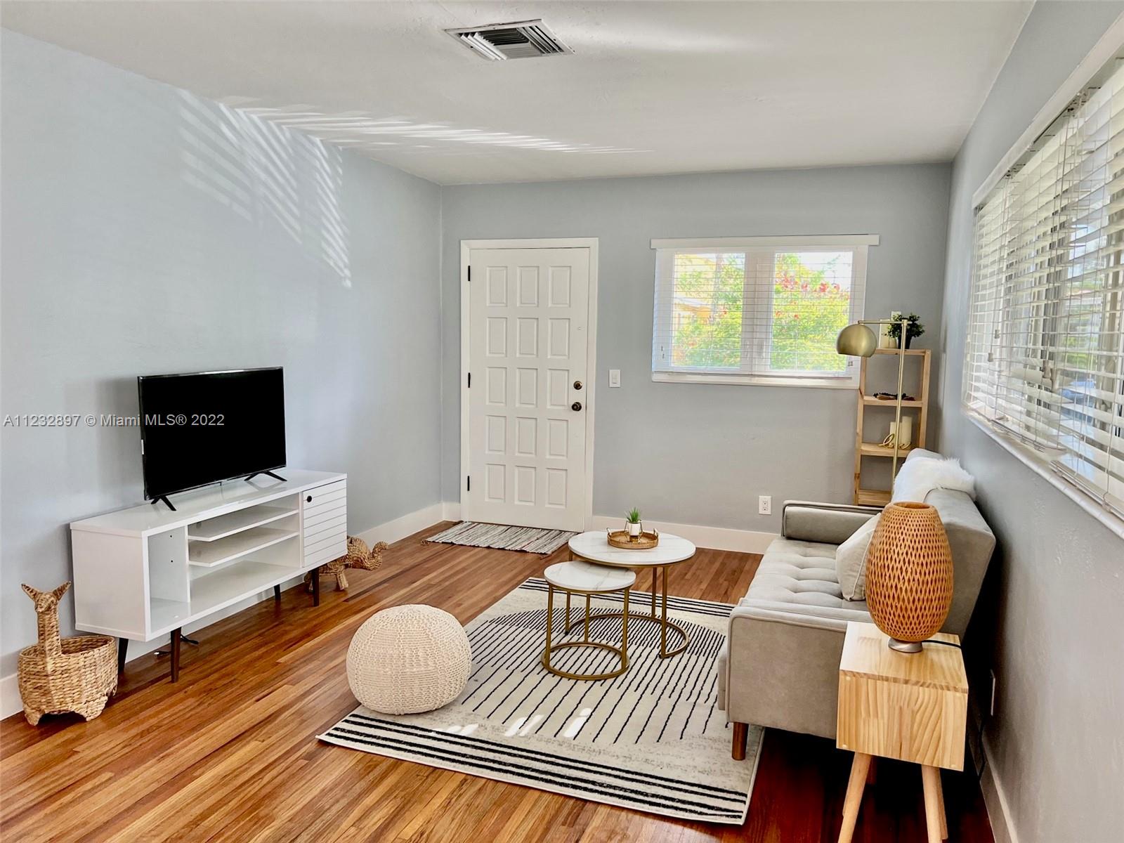 3095 Southwest 21st Street, Unit 1 Miami, FL 33145 - Photo 3 of 15 a living room with furniture and a flat screen tv