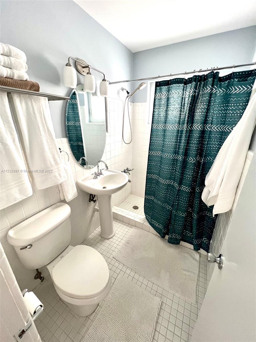 3095 Southwest 21st Street, Unit 1 Miami, FL 33145 - Photo 7 of 15 a bathroom with a sink toilet and shower