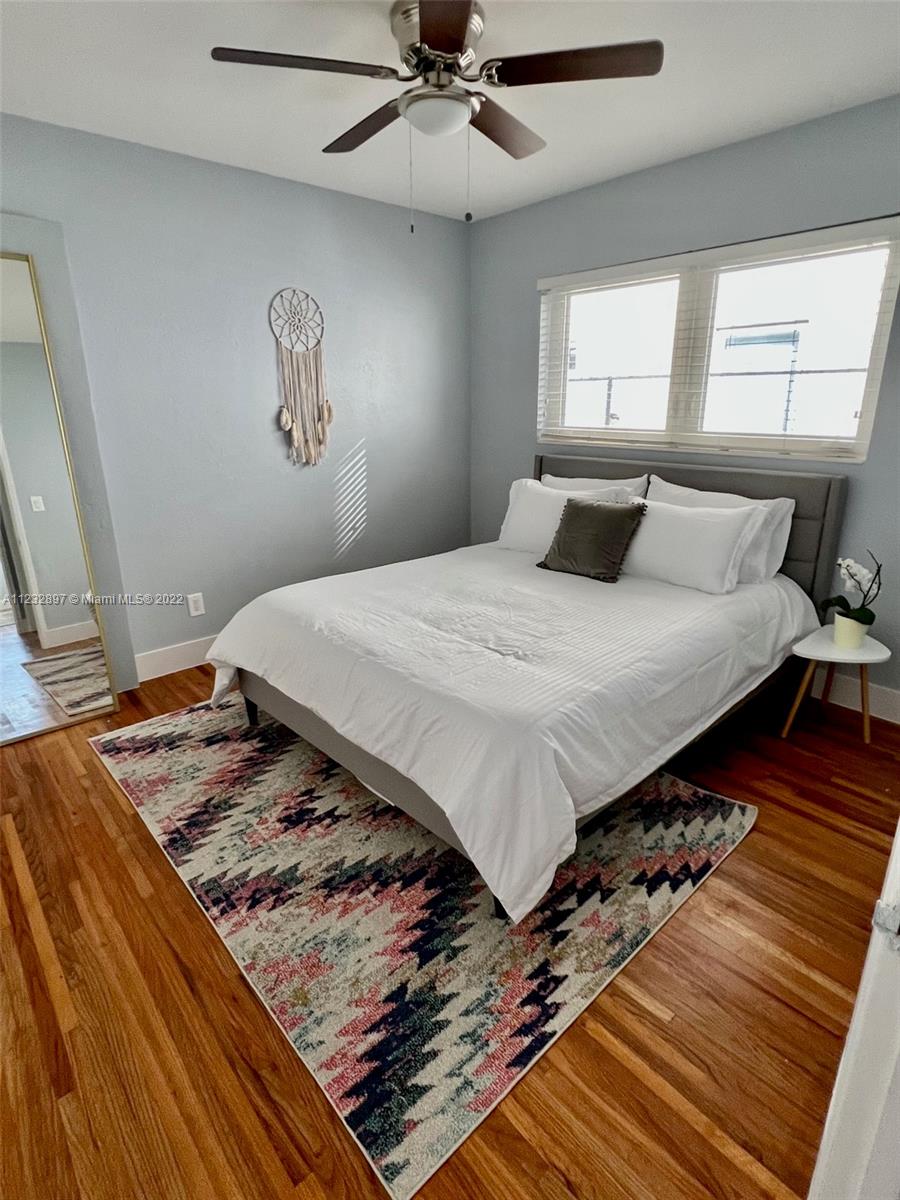 3095 Southwest 21st Street, Unit 1 Miami, FL 33145 - Photo 9 of 15 a bed sitting in a bedroom next to a window