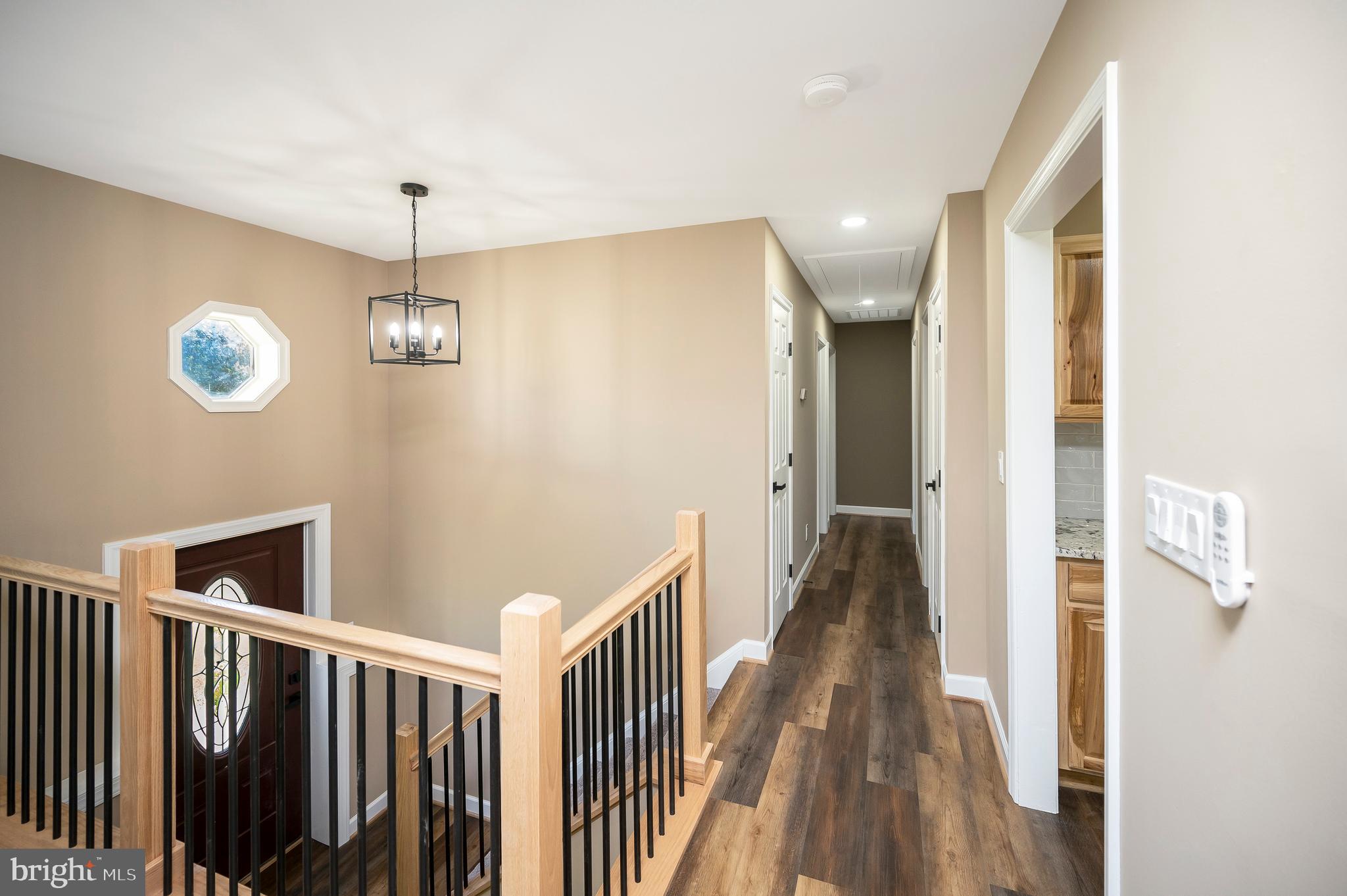 13452 Post Oak Road Spotsylvania, VA 22551 - Photo 16 of 56 a view of a hallway with wooden floor and chandelier