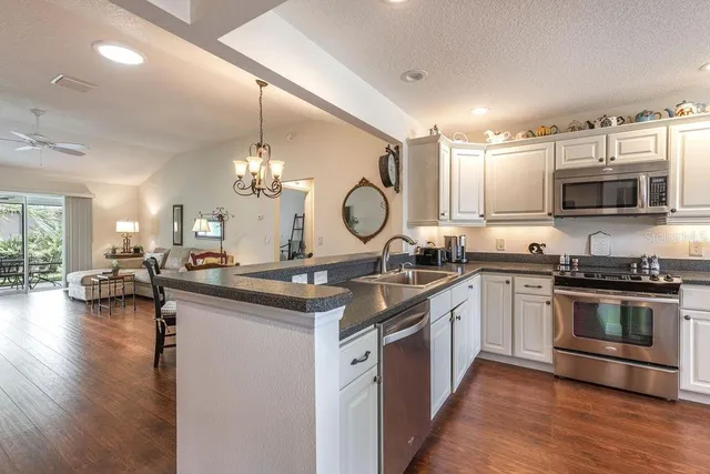 a kitchen with sink stove and cabinets