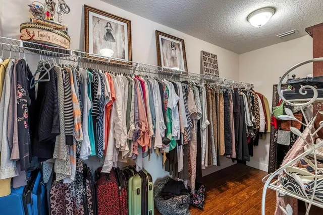 a view of walk in closet with clothes