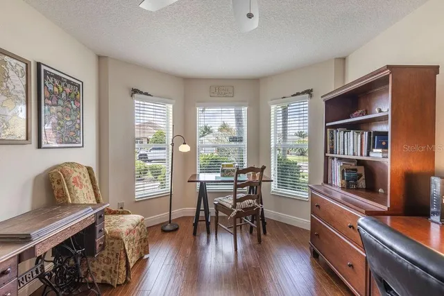 a dining room with furniture window and wooden floor