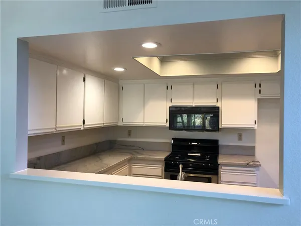 a kitchen with stainless steel appliances a stove and a microwave