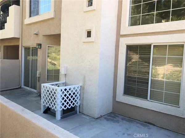 a wooden bench sitting in front of a building
