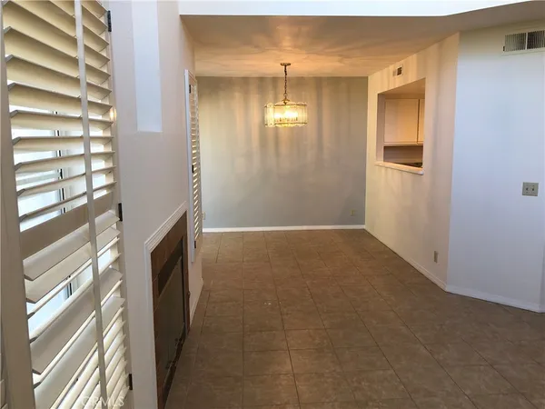 a view of a livingroom with an empty space and a window