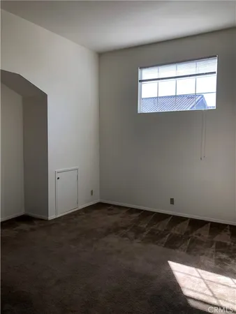 a bathroom with a granite countertop toilet sink and mirror