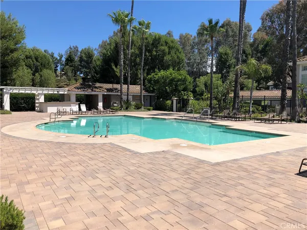 a view of a swimming pool with a yard