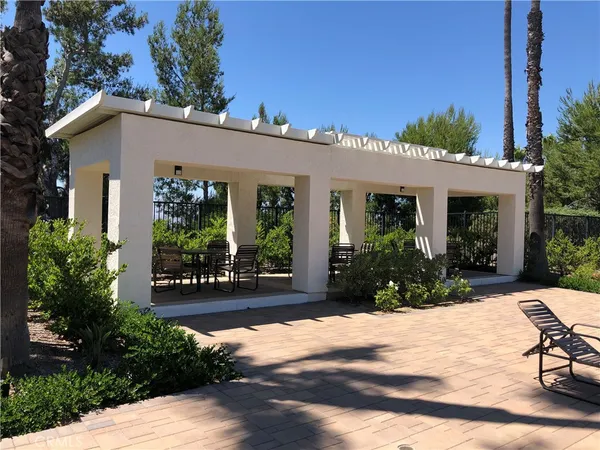 a view of a house with sitting area and garden