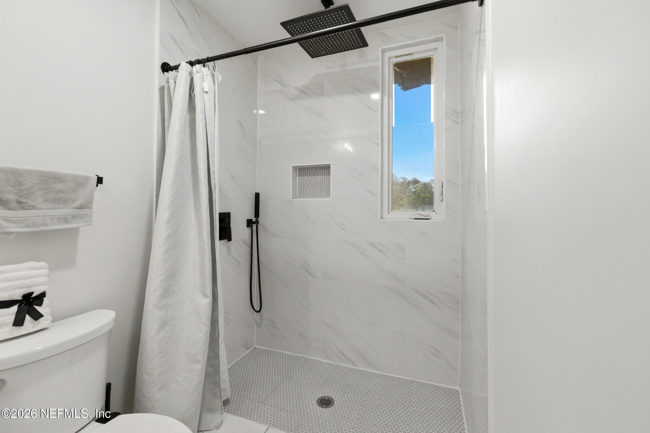7484 Spinola Road Jacksonville, FL 32217 - Photo 34 of 63 a bathroom with a shower a toilet and a sink