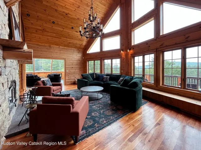 a living room with couch and a floor to ceiling window