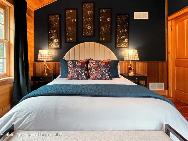 a bed sitting in a bedroom next to a window