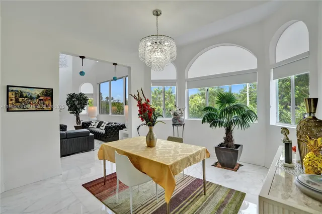 a large white kitchen with cabinets