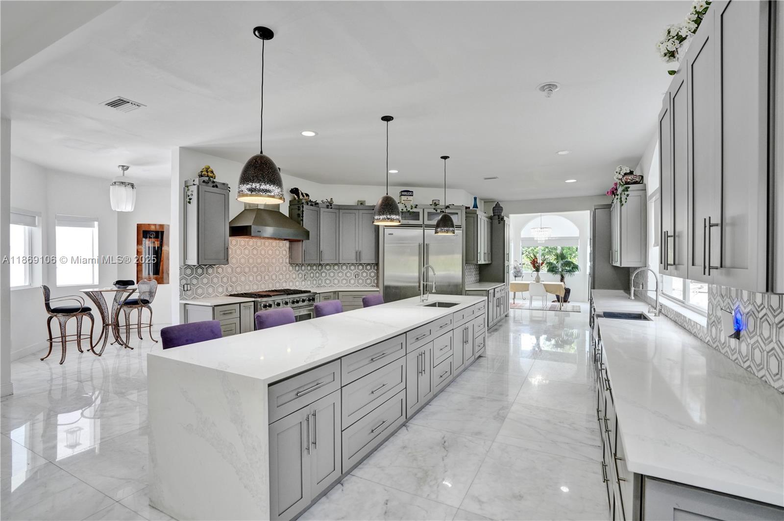 2691 Southwest 139th Terrace Davie, FL 33330 - Photo 23 of 55 a large kitchen with kitchen island a large island in it